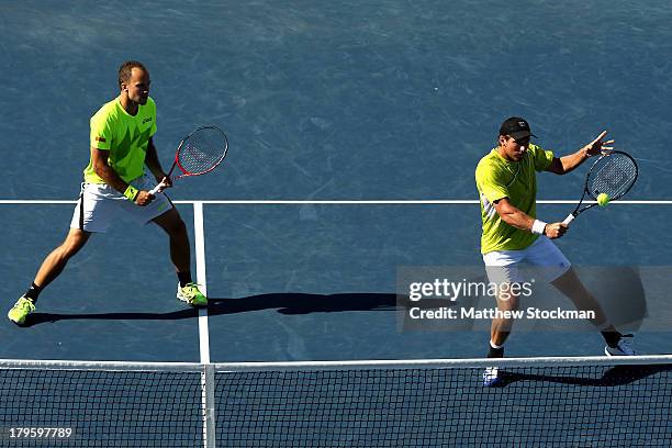 Alexander Peya of Austria plays a backhand next to his partner Bruno Soares of Brazil during their men's doubles semifinal match against Ivan Dodig...