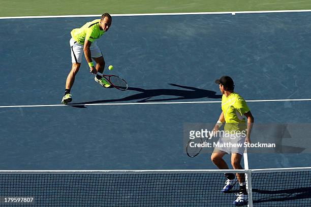 Bruno Soares of Brazil plays a backhand next to his partner Alexander Peya of Austria during their men's doubles semifinal match against Ivan Dodig...