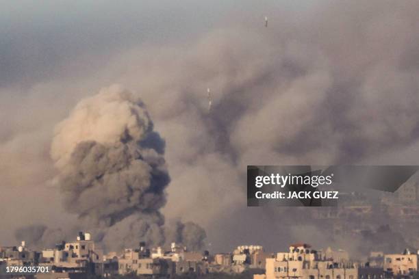 This picture taken from southern Israel near the border with the Gaza Strip shows smoke billowing as bombs drop during an Israeli strike in north...