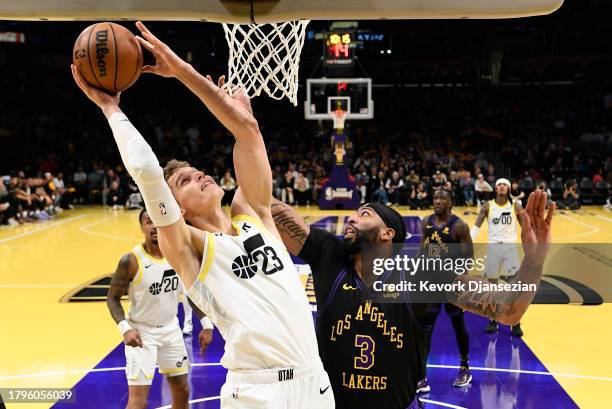 Lauri Markkanen of the Utah Jazz scores basket against Anthony Davis of the Los Angeles Lakers during the first half of an NBA In-Season Tournament...