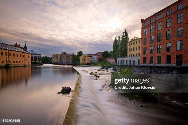 waterfall and houses in norrköping industrial area - norrkoping imagens e fotografias de stock