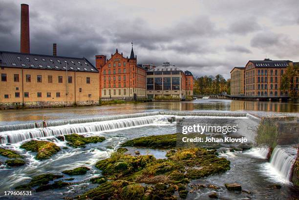 waterfall and houses in norrköping's industry area - norrkoping imagens e fotografias de stock