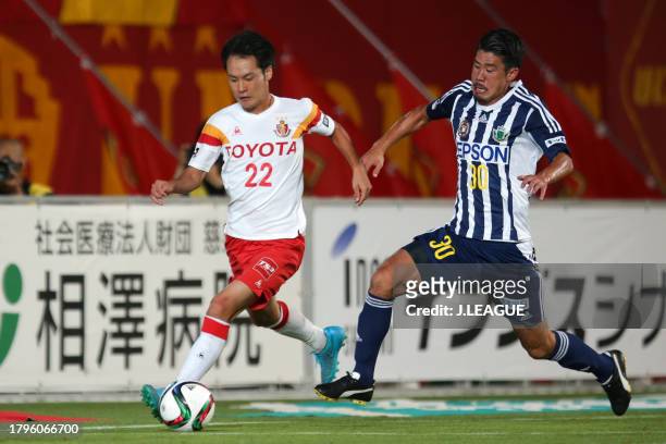 Tomoya Koyamatsu of Nagoya Grampus controls the ball against Ryusuke Sakai of Matsumoto Yamaga during the J.League J1 second stage match between...