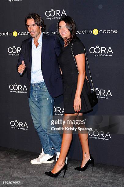 Robert Pires and Jessica Lemarie attend the photocall for 'OORA' Womenswear Collection designed by French singer Matt Pokora at Pavillon Gabriel on...