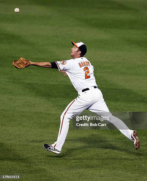 Shortstop J.J. Hardy of the Baltimore Orioles misses a single hit by Conor Gillaspie of the Chicago White Sox during the third inning at Oriole Park...