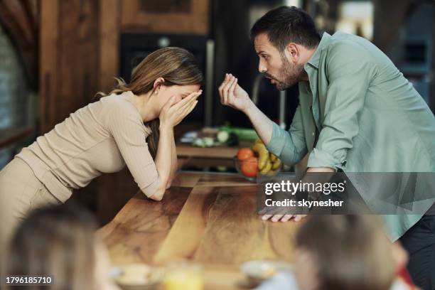 young couple having an argument at home. - divorced dad stock pictures, royalty-free photos & images