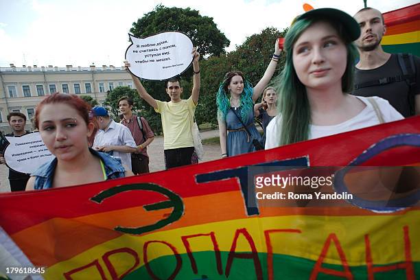 Activists hold a rainbow flag during the Gay Pride rally in St. Petersburg, Russia. Demonstrating LGBT activists and the Russian nationalists that...