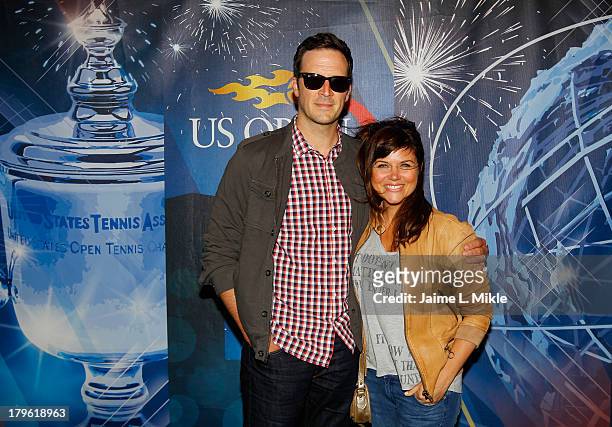 Actress Tiffani Amber Thiessen smiles alongside husband and actor Brady Smith while attending Day Eleven of the 2013 US Open at the USTA Billie Jean...