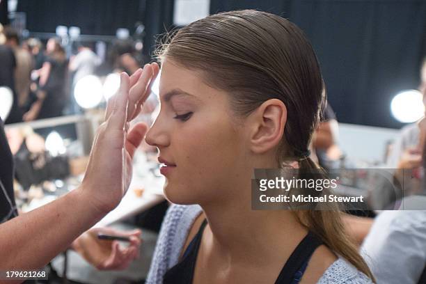Model prepares backstage before the Tadashi Shoji show during Spring 2014 Mercedes-Benz Fashion Week at The Stage at Lincoln Center on September 5,...