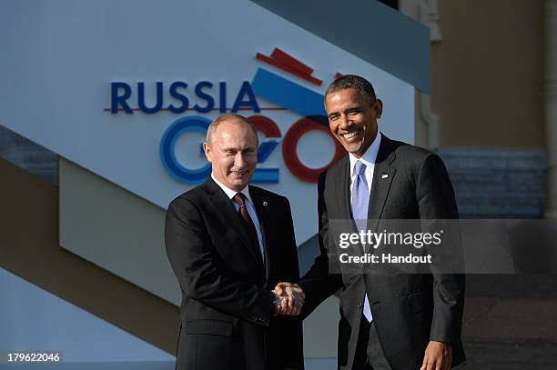 In this handout image provided by Host Photo Agency, Russian President Vladimir Putin greets U.S. President Barack Obama at the G20 summit on...