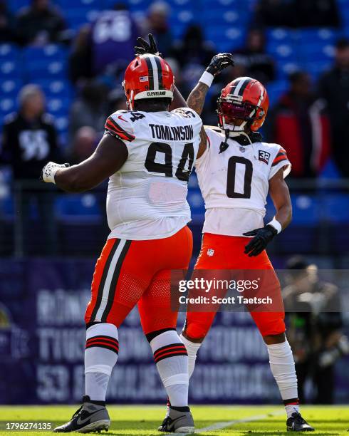 Dalvin Tomlinson and Greg Newsome II of the Cleveland Browns interact before the game against the Baltimore Ravens at M&T Bank Stadium on November...