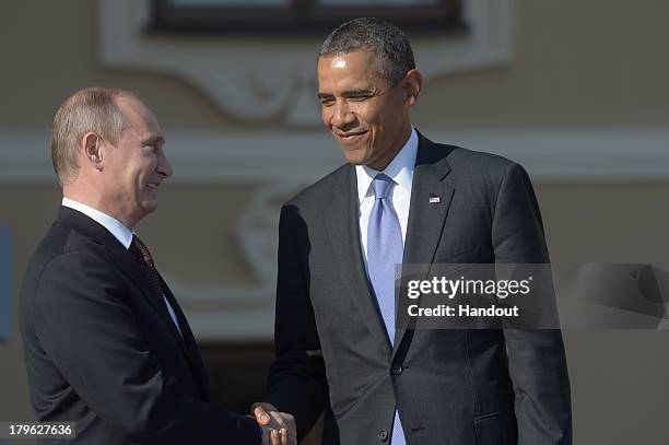 In this handout image provided by Host Photo Agency, Russian President Vladimir Putin greets U.S. President Barack Obama at the G20 summit on...