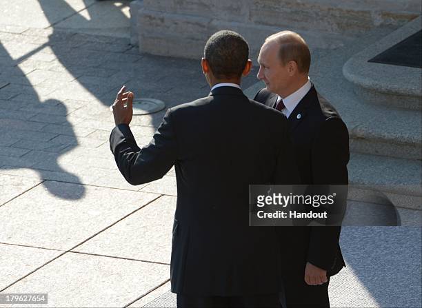 In this handout image provided by Host Photo Agency, Russian President Vladimir Putin greets U.S. President Barack Obama at the G20 summit on...