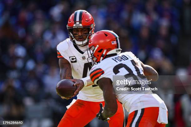 Deshaun Watson of the Cleveland Browns Hans the ball off to Jerome Ford during the first half against the Baltimore Ravens at M&T Bank Stadium on...