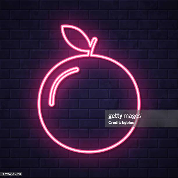 orange. glowing neon icon on brick wall background - nectarine stock illustrations