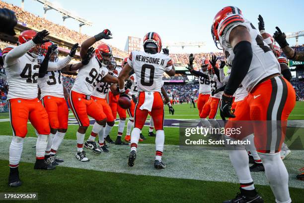 Greg Newsome II of the Cleveland Browns celebrates with teammates after returning an interception for a touchdown during the second half against the...