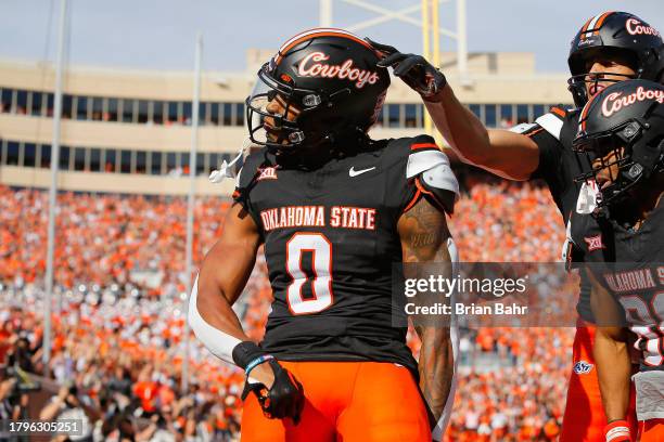 Running back Ollie Gordon II of the Oklahoma State Cowboys celebrates a 20-yard touchdown run against the Oklahoma Sooners in the first quarter of...