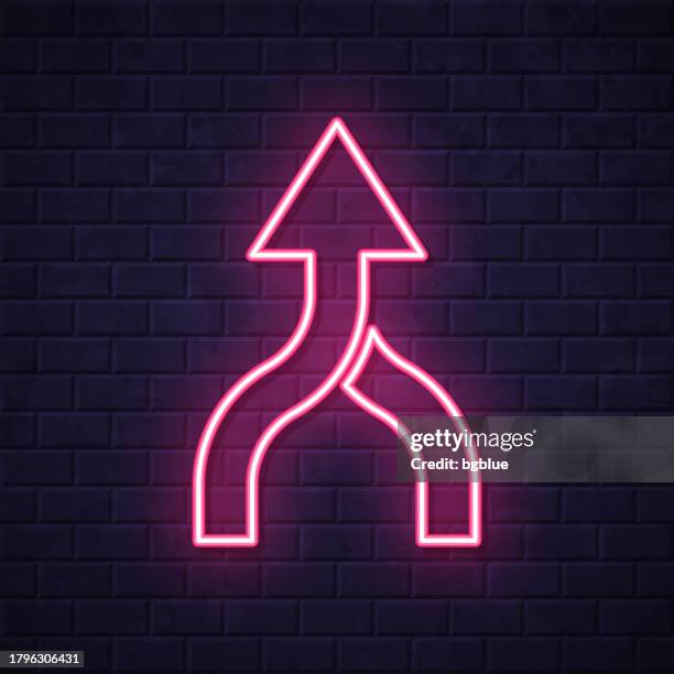 direction arrow merge. glowing neon icon on brick wall background - roads merging stock illustrations