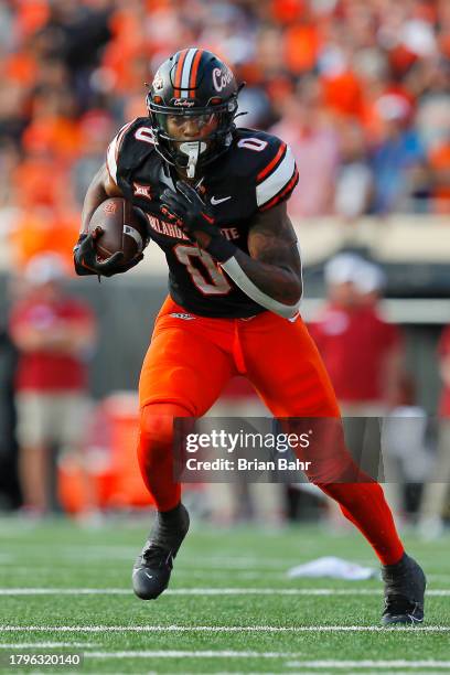 Running back Ollie Gordon II of the Oklahoma State Cowboys carries the ball against the Oklahoma Sooners in the third quarter of Bedlam at Boone...