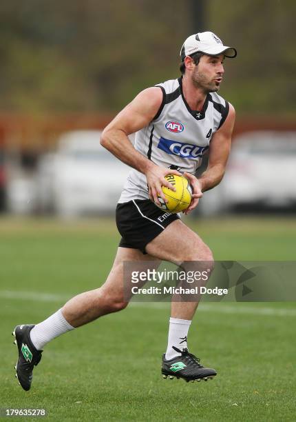 Alan Didak runs with the ball during a Collingwood Magpies AFL training session at Olympic Park on September 6, 2013 in Melbourne, Australia.