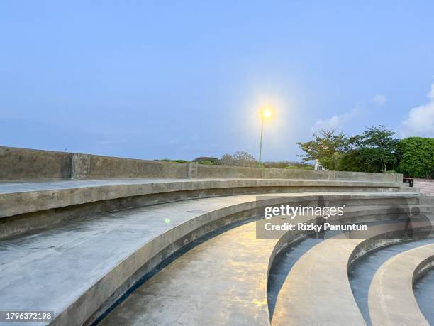 scenic view of concrete tribune against blue sky background - tribune tower stock pictures, royalty-free photos & images