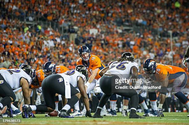 Quarterback Peyton Manning of the Denver Broncos audibles at the line of scrimmage against the Baltimore Ravens during the game at Sports Authority...