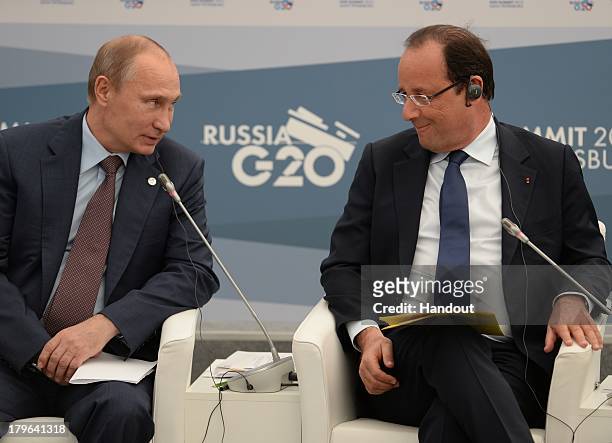 In this handout image provided by Host Photo Agency, Russian President Vladimir Putin and French President Francois Hollande attend a meeting with...