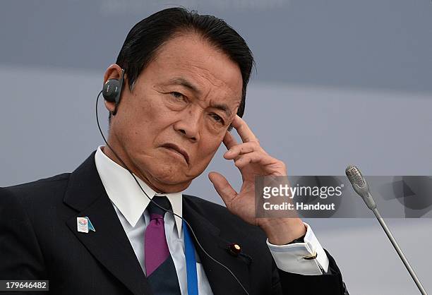 In this handout image provided by Host Photo Agency, Japanese Finance Minister Taro Aso attends a meeting with Business 20 and Labour 20...