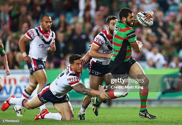 Greg Inglis of the Rabbitohs beats the tackle of Sonny-Bill Williams of the Roosters to score a try during the round 26 NRL match between the South...