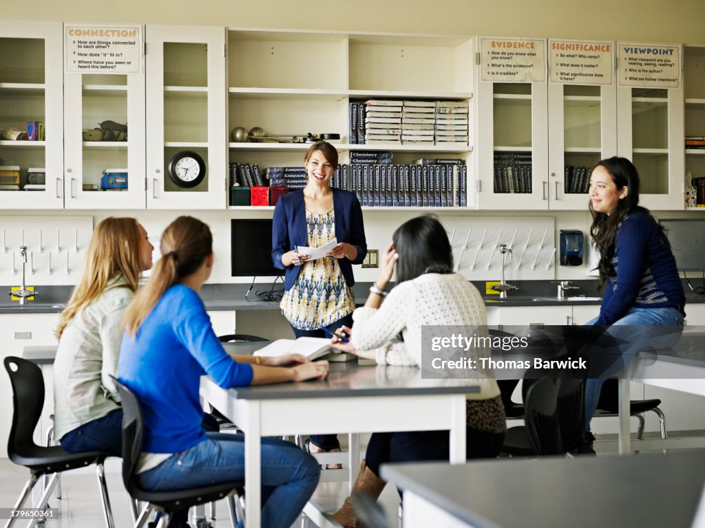 Educators Discussion Teacher In Discussion With Students In Classroom High-Res Stock Photo ...