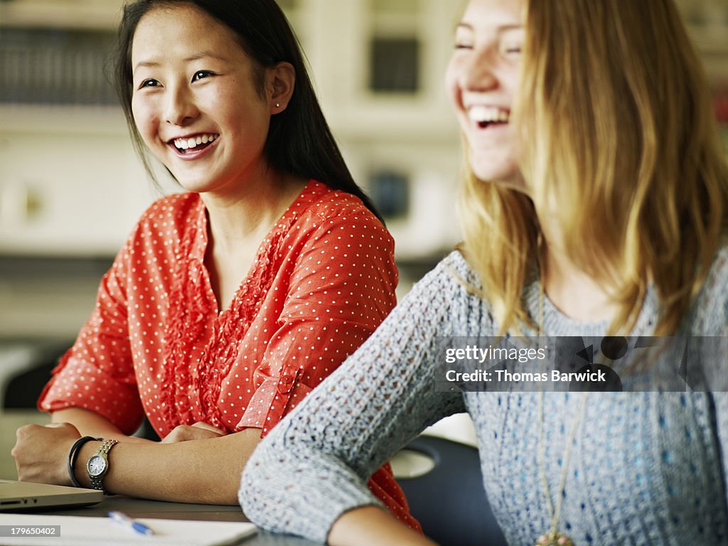 Two female students studying together in classroom