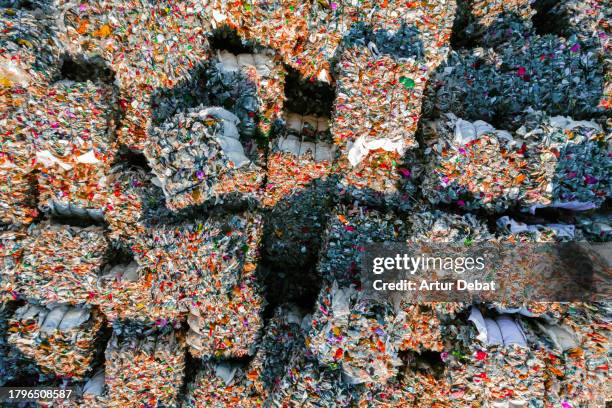 directly above view of a piles of crushed plastic bales stacking in a recycling plant. - junk stock pictures, royalty-free photos & images