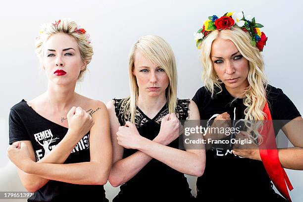 Activists Sasha Shevchenko and Inna Shevchenko pose with director Kitty Green during the 'Femen' Portrait Session for the film 'Ukraine Is Not A...