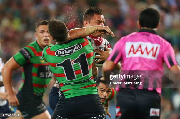 Jared Waerea-Hargreaves of the Roosters strikes Chris McQueen of the Rabbitohs with his elbow in a tackle during the round 26 NRL match between the...
