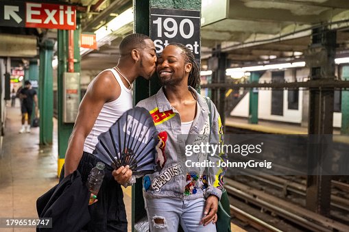 Black couple waiting for train on subway platform Black couple waiting for train on subway platform