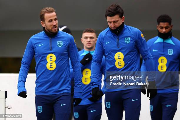 Harry Kane and Harry Maguire of England look on during an England Training Session at St Georges Park on November 16, 2023 in Burton-upon-Trent,...
