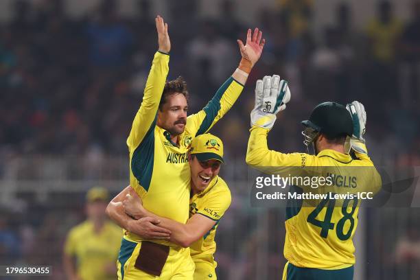 Travis Head of Australia celebrates with teammates after bowling out Heinrich Klaasen of South Africa during the ICC Men's Cricket World Cup India...