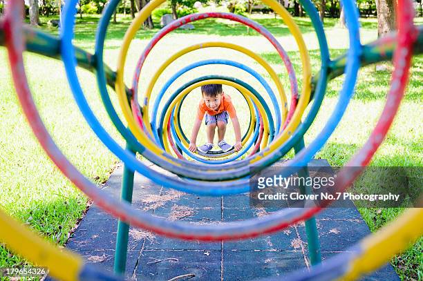 little boy playing a game circled climb. - elementary student stock pictures, royalty-free photos & images