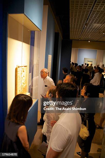 Guests watch the 'Madonna of the Stairs' by Michelangelo Buonarroti during the preview of the exhibition 'Michelangelo Buonarroti - The Making of a...