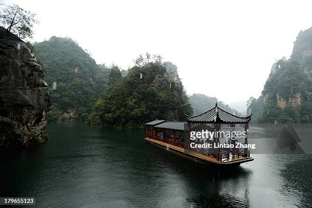 Tourists are seen on sightseeing cruises at the Baofeng Lake on September 1, 2013 in Zhangjiajie, China. Zhangjiajie National Forest park is a...
