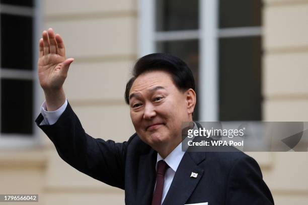 South Korea's President Yoon Suk Yeol gestures as he leaves the Royal Society, November 22, 2023 in London, United Kingdom.