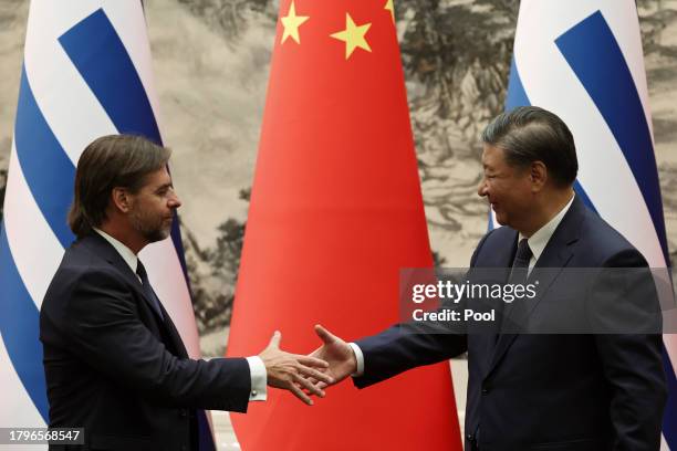 Chinese President Xi Jinping and Uruguay President Luis Lacalle Pou shake hands during a signing ceremony at The Great Hall of the People on November...