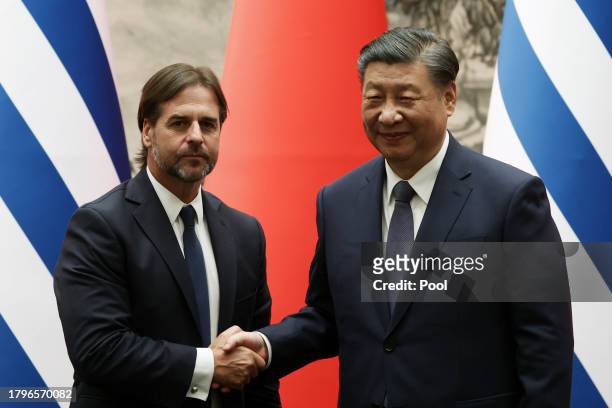Chinese President Xi Jinping and Uruguay President Luis Lacalle Pou shake hands during a signing ceremony at The Great Hall of the People on November...