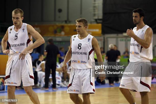 Niels Giffey, Heiko Schaffartzik and Philip Zwiener of Gemany look dejected during the FIBA European Championships 2013 first round group A match...