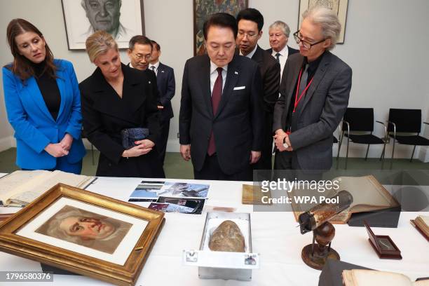 South Korea's President Yoon Suk Yeol looks at the death mask of Isaac Newton, next to Britain's Sophie, the Duchess of Edinburgh, Britain's...