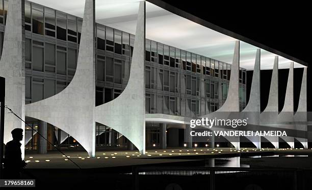 An army soldier guards the Planalto Palace in Brasilia on September 5 two-day before Independence Day military parade which will be attended by...