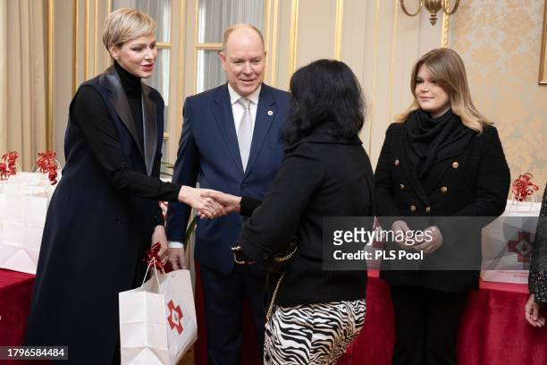Princess Charlene of Monaco and Prince Albert II of attend the Red Cross Gifts Distribution on November 16, 2023 in Monaco, Monaco.