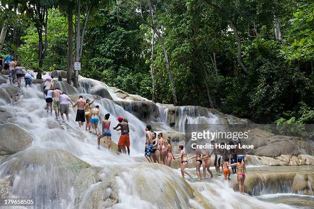 people climb dunn's river falls - dunns river falls stock pictures, royalty-free photos & images