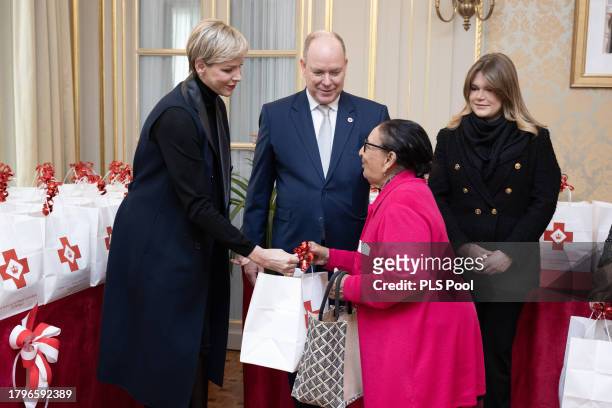 Princess Charlene of Monaco, Prince Albert II of Monaco and Camille Gottlieb attend the Red Cross Gifts Distribution on November 16, 2023 in Monaco,...