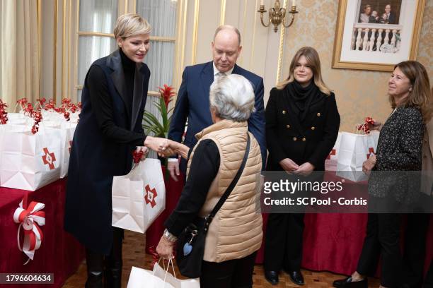 Princess Charlene of Monaco, Prince Albert II of Monaco and Camille Gottlieb attend the Red Cross Gifts Distribution at Monaco Palace on November 16,...
